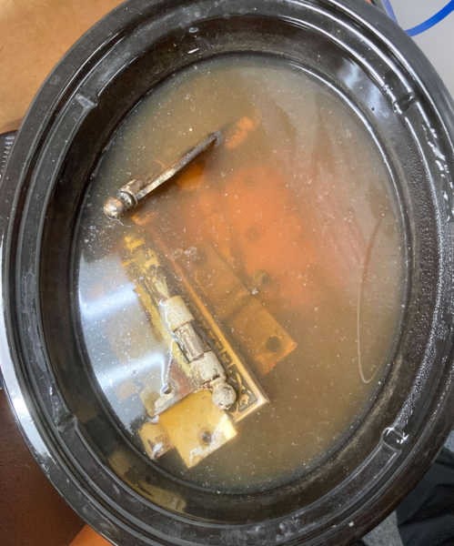 Soak painted vintage hardware in a crock pot for several hours. This will make the paint easy to peel right off.